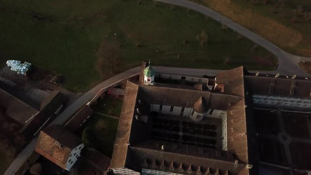 Aerial drone shot orbiting increasingly around Fahr Monastery in Unterengstringen, Switzerland