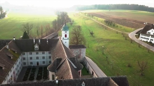 Aerial drone shot flying over Fahr Monastery in Unterengstringen, Switzerland