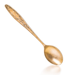 vintage gold spoon with reflection on an isolated white background