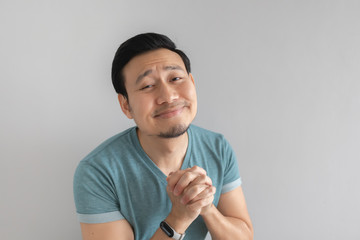 Man is begging for something on grey background.