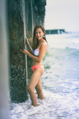beautiful asian younger woman wearing bikini  on sea beach with smiling face