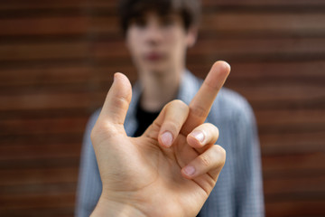 showing a middle finger to the person. disrespect sign