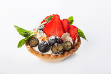 The round shape of the unleavened dough is filled with a snack of berries and cheese. Capacity of dough for toppings. View from above. Copy space