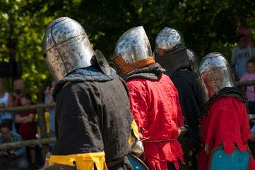 Knights in full armor are fighting in the arena. Medieval knight in the arena. Medieval knight in the Knight battles at the festival of medieval culture.