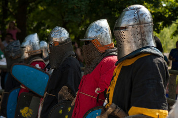 Knights in full armor are fighting in the arena. Medieval knight in the arena. Medieval knight in the Knight battles at the festival of medieval culture.