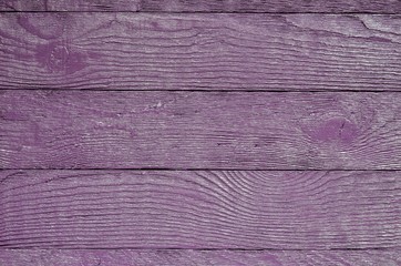 Wooden background texture. Creatively painted intense violet boards.