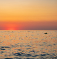 Sunny sunset on a warm and clear sea