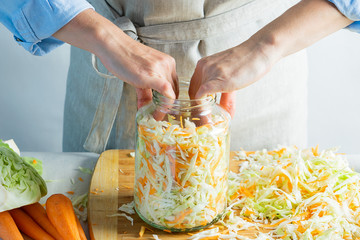 The preparation process fermentation preservation Sauerkraut on a light background. Natural rustic style. Canned food