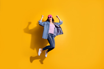 Fototapeta na wymiar Full body photo of funky lady jumping high overjoyed by discount shopping prices wear casual trendy clothes isolated yellow color background