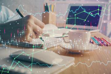 Financial chart drawn over hands taking notes background. Concept of research. Double exposure