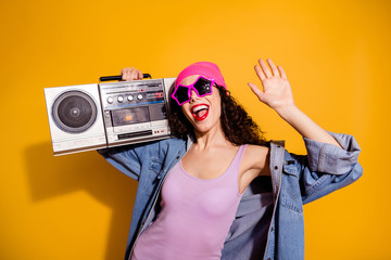 Photo of crazy lady with tape recorder on shoulder chilling at disco party wear casual trendy clothes isolated yellow color background