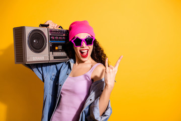 Photo of nice lady with tape recorder on shoulder listening metal song making horns symbol wear casual trendy clothes isolated yellow color background