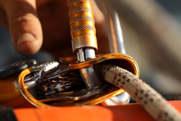 Close up rope access inspector hand inspecting self controller stopper a fall descent safe device...