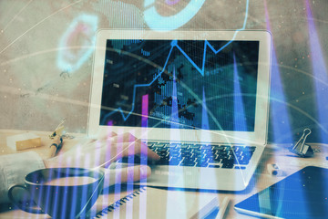 Forex graph with businessman working on laptop on background. Concept of hardworking. Multi exposure.