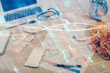 Financial market graph hologram and personal computer on background. Double exposure. Concept of forex.