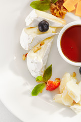 Gourmet, restaurant, delicious dinner food - close up of cheese plate with honey dip and fresh berries