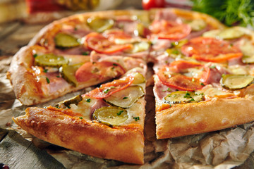 Pizza Restaurant Menu - Delicious Fresh Pizza with Tomato, Ham and Pickled Cucumber. Pizza on Rustic Wooden Table with Ingredients