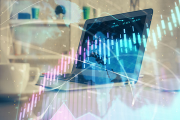 Stock market chart hologram drawn on personal computer background. Double exposure. Concept of investment.