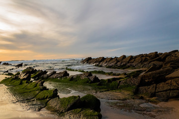 sunset at Barrika beach next to the rocks