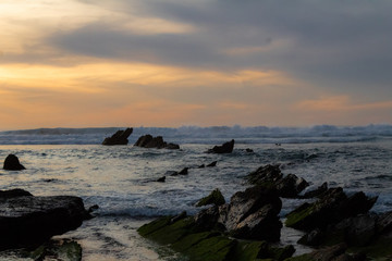 sunset at Barrika beach next to the rocks