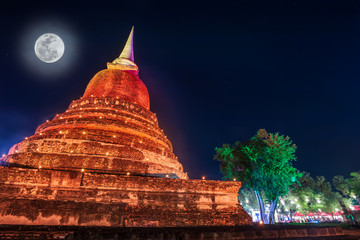 Beautiful scene light color Sukhothai Co Lamplighter Loy Kratong Festival party at The Sukhothai Historical temple park covers the ruins of Sukhothai, in what is now Northern Thailand. With full moon