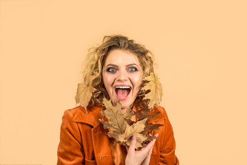 Beautiful fashion female with autumnal make up and hair style. Beauty woman in autumn yellow dress. Fashionable stylish girl with autumn leaves. Fashion autumn portrait stylish woman. Autumn fashion.