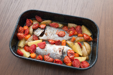 Fresh Baked fish with vegetables and potatoes in pan