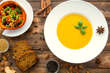 Thanksgiving dinner. Pumpkin soup, roasted pumpkin with vegetables. Traditional autumn food concept.
