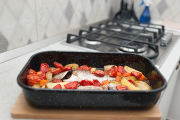 Fresh Baked fish with vegetables and potatoes in pan