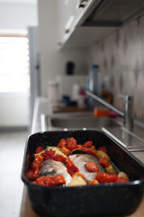 Fresh Baked fish with vegetables and potatoes in pan