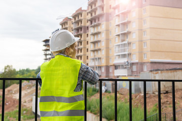 Woman Builder working on a construction site at home