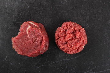 Chopped beef tenderloin. Raw meat on black stone