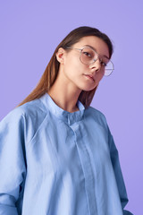 Trendy woman in glasses looking at camera