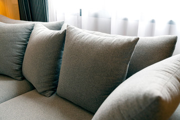 close up of soft fabric pillow decoration on beautiful sofa in living room home design concept