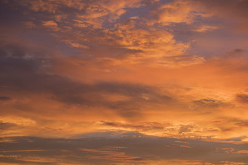 Naklejka na ściany i meble Orange sky background with clouds