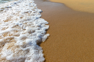 Small wave on golden sand, Corsica, France