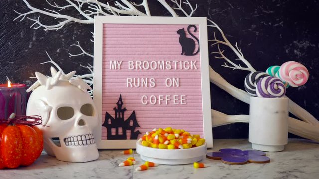 Funny Halloween mantel table set up with My Broomstick Runs on Coffee letter board. Static shot with woman drinking coffee