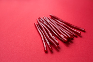  red licorice sticks on a red background