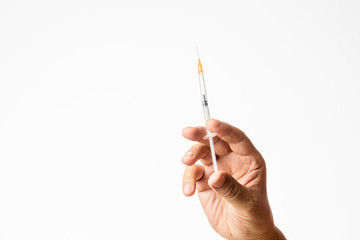 male hand holding a small charged syringe and needle isolated in white background