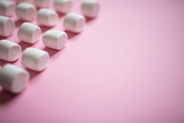 Obraz na płótnie Canvas wallpaper with white marshmallows on a pink background