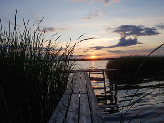 Evening lake. Untouched nature. Romantic outdoor recreation. Traveling in untouched natural places. Sunset in the reeds.
