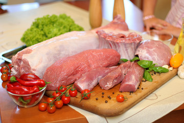 Pork .Raw meat in a composition with herbs, spices and vegetables