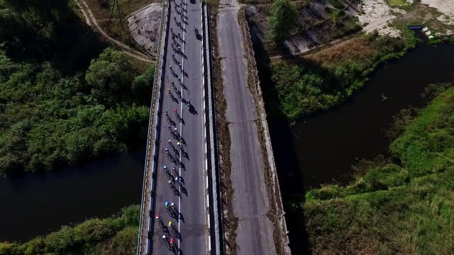 Bicyclist group riding on bike ride at highway. Drone view cycling competition