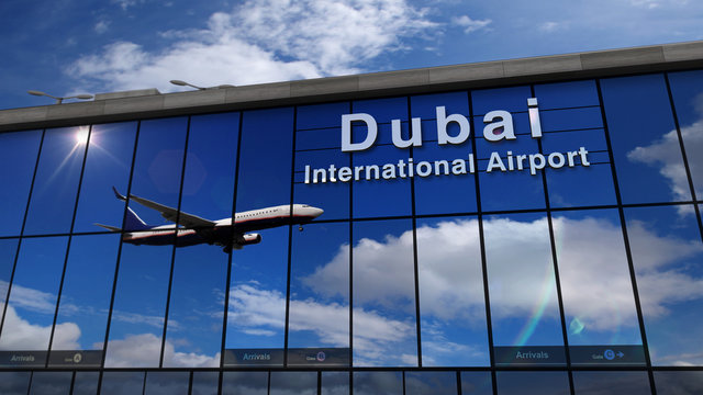 Airplane landing at Dubai mirrored in terminal