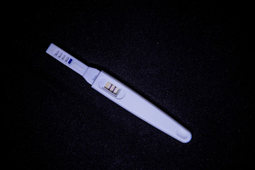 Pregnancy test kit Black background