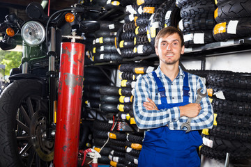 young male mechanic working in auto repair shop