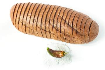 Rye bread with red chili peppers and salt on a white background isolated.