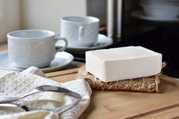 Handmade vegan dish washing block in the kitchen, zero waste product, clean dishes and sink on background