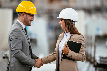 Businessman and businesswoman handshaking