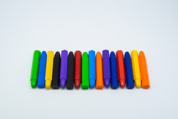 School supplies, colourful crayons stationery on white background.
